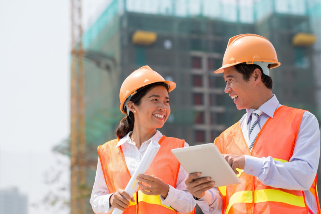 Join our team Construction team discussing while smiling